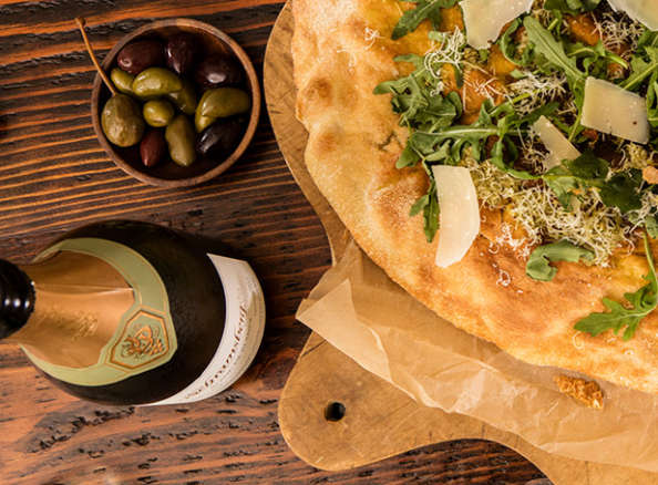 Schramsberg Blanc de Blanc sparkling wine paired with Greek olives and arugula and Parmesan flatbread
