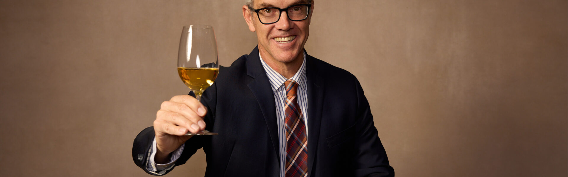 Hugh Davies raising a glass of sparkling. Photo Credit: Rick Wenner/Wine Spectator