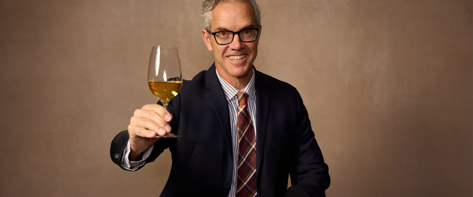 Hugh Davies raising a glass of sparkling. Photo Credit: Rick Wenner/Wine Spectator