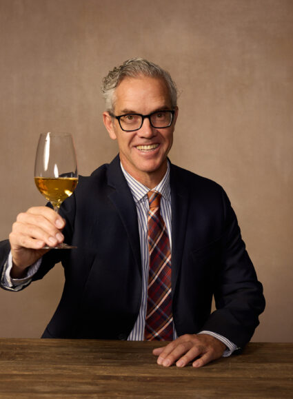 Hugh Davies raising a glass of sparkling. Photo Credit: Rick Wenner/Wine Spectator